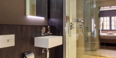 Guest bathroom with shower and free toiletries at Bloc Hotel Birmingham.