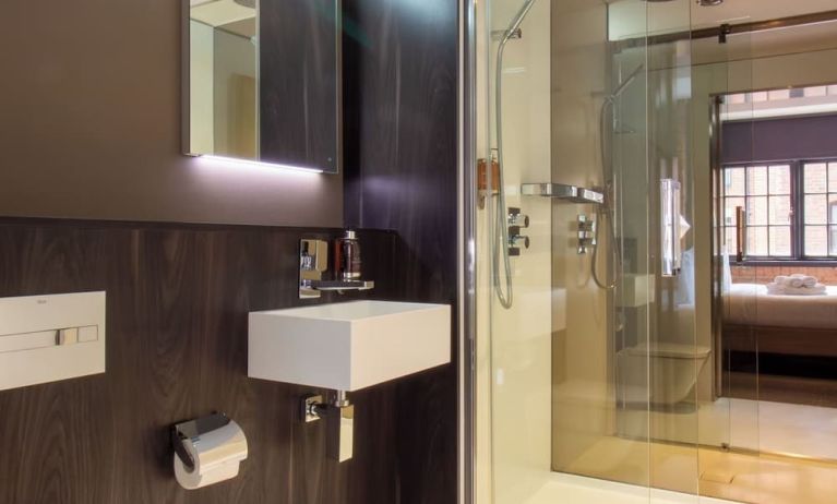 Guest bathroom with shower and free toiletries at Bloc Hotel Birmingham.