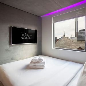 Day use room with TV screen and city view at Bloc Hotel Birmingham.