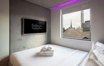 Day use room with TV screen and city view at Bloc Hotel Birmingham.