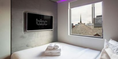 Day use room with TV screen and city view at Bloc Hotel Birmingham.