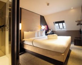 Day use room with king bed and private bathroom with shower at Bloc Hotel Birmingham.