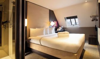 Day use room with king bed and private bathroom with shower at Bloc Hotel Birmingham.