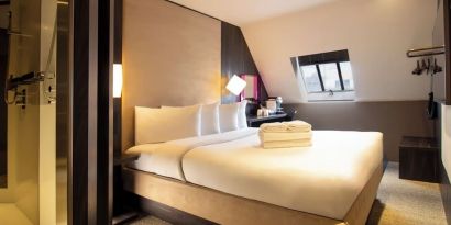 Day use room with king bed and private bathroom with shower at Bloc Hotel Birmingham.