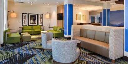 Lobby and coworking lounge at Holiday Inn Express & Suites Ottumwa.