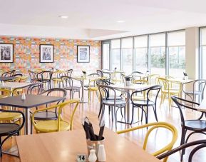 Comfortable dining area with floor to ceiling windows, perfect for co-working at Ibis Styles Barnsley.