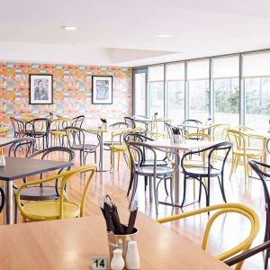 Comfortable dining area with floor to ceiling windows, perfect for co-working at Ibis Styles Barnsley.