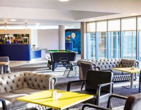 Hotel bar with lounge seating and billiards at Ibis Styles Barnsley.