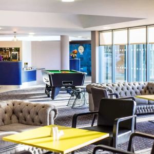 Hotel bar with lounge seating and billiards at Ibis Styles Barnsley.