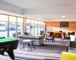 Lobby lounge with comfortable seating and billiards at Ibis Styles Barnsley.