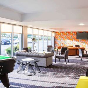 Lobby lounge with comfortable seating and billiards at Ibis Styles Barnsley.