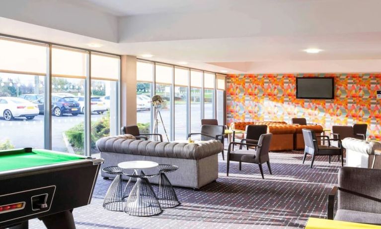 Lobby lounge with comfortable seating and billiards at Ibis Styles Barnsley.