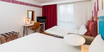 Day use family room with king bed, convertible sofa and work desk at Ibis Styles Barnsley.