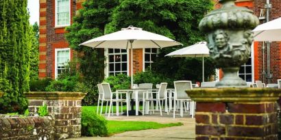 Outdoor lounge with beautiful view of the garden at Barnett Hill Hotel.