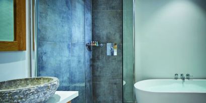 Private bathroom with tub and shower at Barnett Hill Hotel.