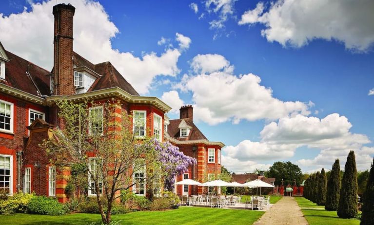 Hotel exterior with lounge seating at Barnett Hill Hotel.