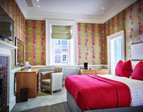 Day use room with work desk, TV screen and fireplace at Barnett Hill Hotel.