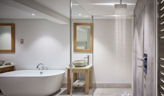 Guest bathroom with shower and tub at Barnett Hill Hotel.