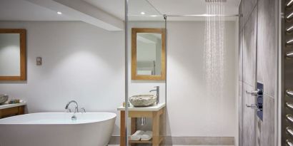 Guest bathroom with shower and tub at Barnett Hill Hotel.