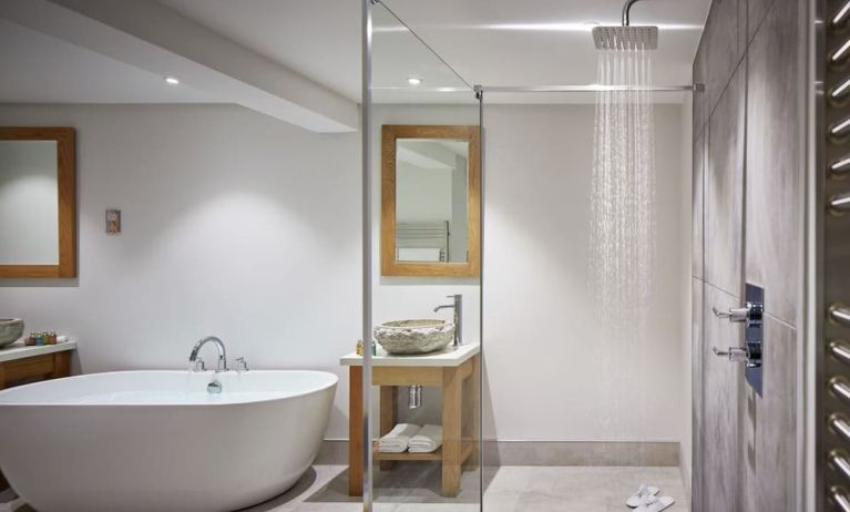 Guest bathroom with shower and tub at Barnett Hill Hotel.