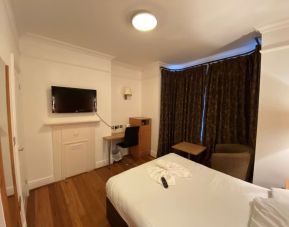 Day use room with TV screen and work desk at Buckingham Hotel.