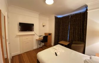 Day use room with TV screen and work desk at Buckingham Hotel.