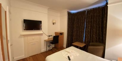 Day use room with TV screen and work desk at Buckingham Hotel.