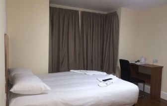 Day use room with king bed and work desk at Buckingham Hotel.