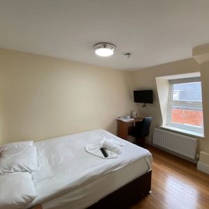 Standard day use room with TV screen and work desk at Buckingham Hotel.