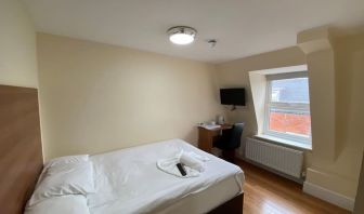 Standard day use room with TV screen and work desk at Buckingham Hotel.