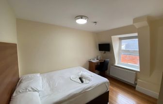 Standard day use room with TV screen and work desk at Buckingham Hotel.