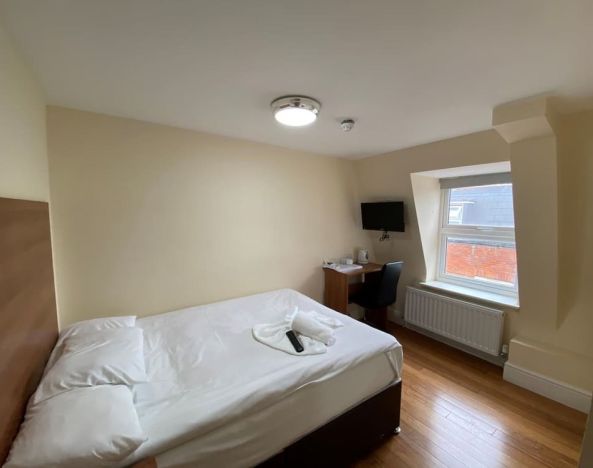 Standard day use room with TV screen and work desk at Buckingham Hotel.