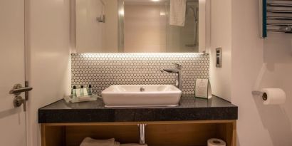 Guest bathroom with shower and free toiletries at Holiday Inn Leicester-Wigston.