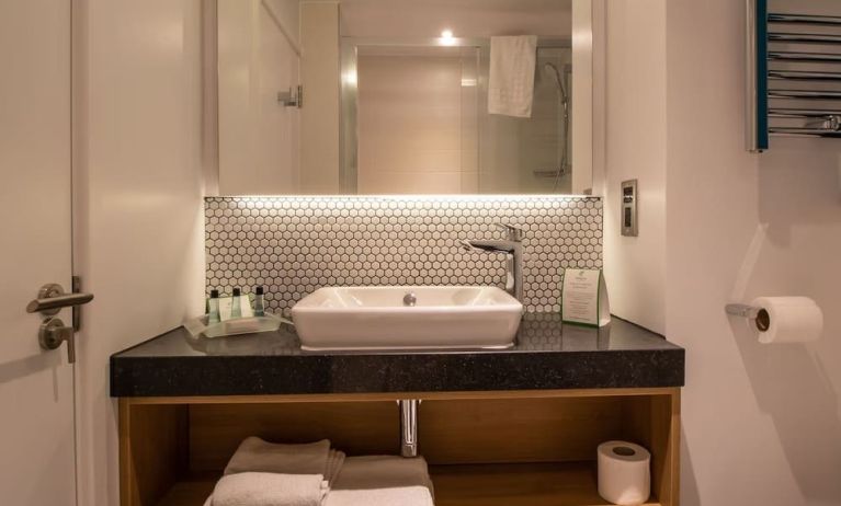 Guest bathroom with shower and free toiletries at Holiday Inn Leicester-Wigston.