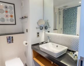 Guest bathroom with shower and free toiletries at Holiday Inn Leicester-Wigston.