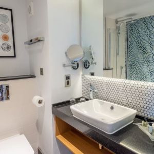 Guest bathroom with shower and free toiletries at Holiday Inn Leicester-Wigston.