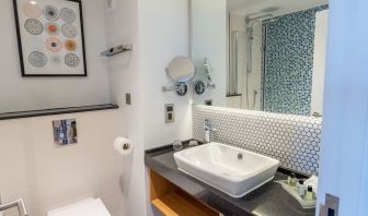 Guest bathroom with shower and free toiletries at Holiday Inn Leicester-Wigston.