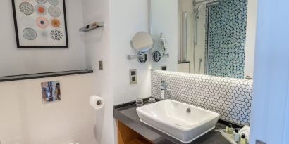 Guest bathroom with shower and free toiletries at Holiday Inn Leicester-Wigston.