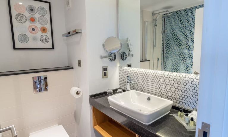 Guest bathroom with shower and free toiletries at Holiday Inn Leicester-Wigston.