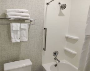 Guest bathroom with shower and tub at Holiday Inn Express Newberg - Wine Country.