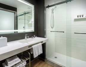 Guest bathroom with shower at AC Hotel By Marriott SFO/Oyster Point Waterfront.