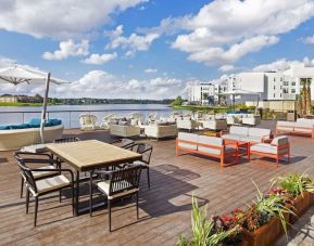 Outdoor furniture with an amazing view of the lake at Hyatt Place Jacksonville / St. Johns Town Center.