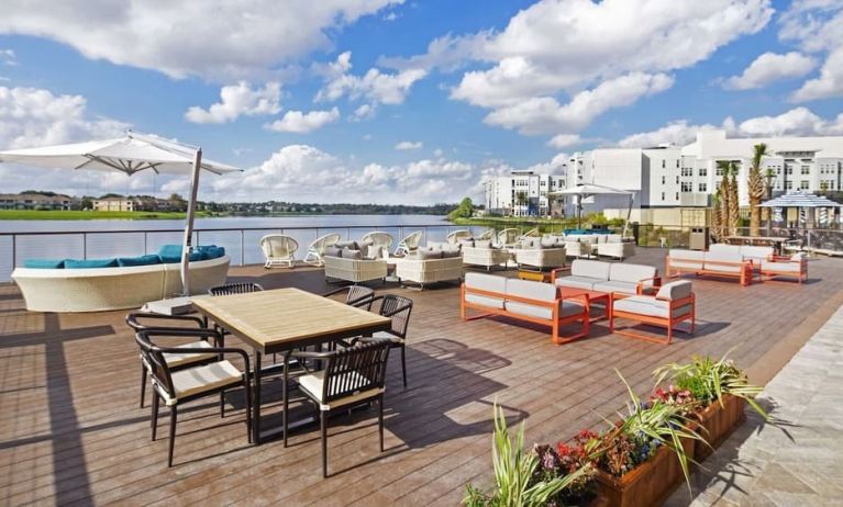 Outdoor furniture with an amazing view of the lake at Hyatt Place Jacksonville / St. Johns Town Center.