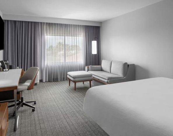 Spacious day use room with sofa and work desk at Courtyard By Marriott Tampa Oldsmar.