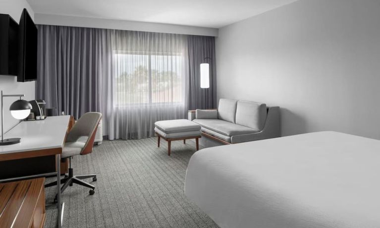 Spacious day use room with sofa and work desk at Courtyard By Marriott Tampa Oldsmar.