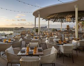 Poolside bar with ample seats at The Ben, Autograph Collection.