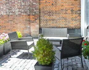 Outdoor patio with lounge seating at Hotel Shepherds Bush London.