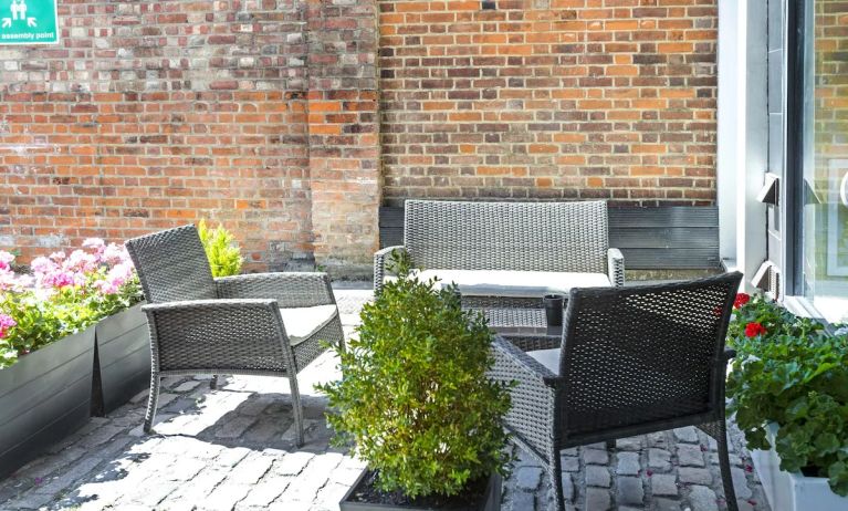 Outdoor patio with lounge seating at Hotel Shepherds Bush London.