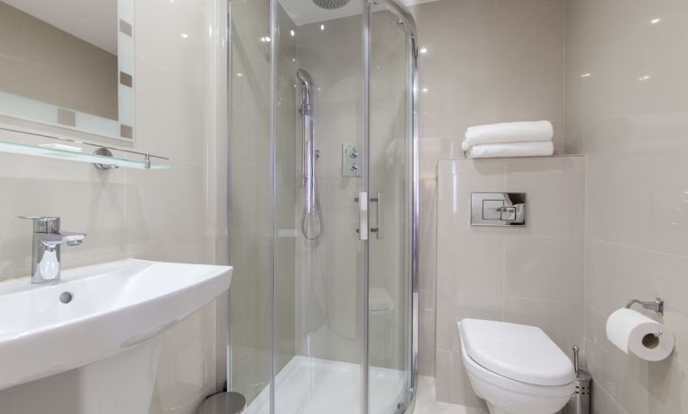 Private bathroom with shower and free toiletries at Hotel Shepherds Bush London.