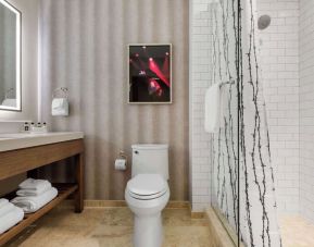 Guest bathroom with shower at Cambria Hotel Nashville Downtown.